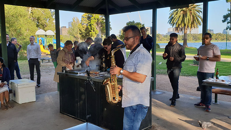 bbq at melbourne office with employee playing saxaphone