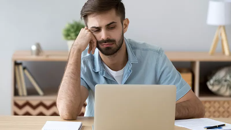 depressed man at computer