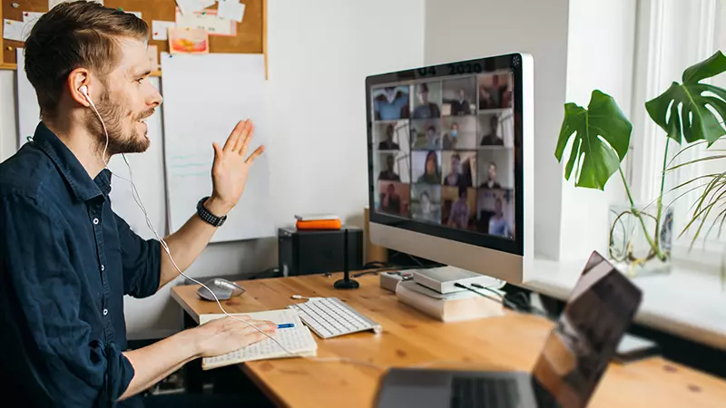 man waves during webinar