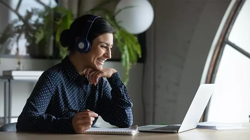 woman smiles during webinar