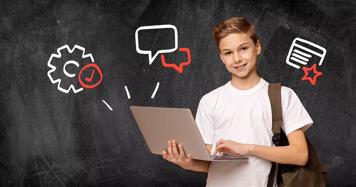 School Child uses laptop against chalkboard background with drawings