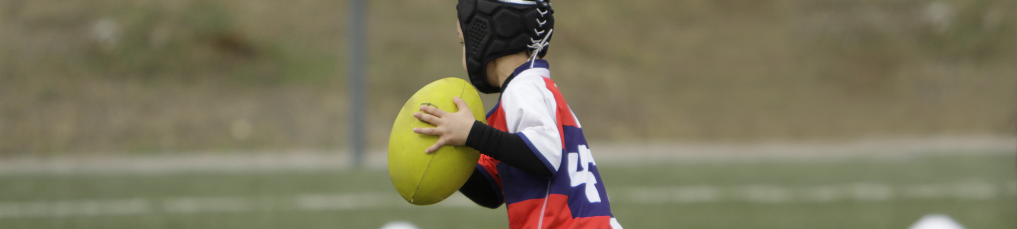 child playing rugby