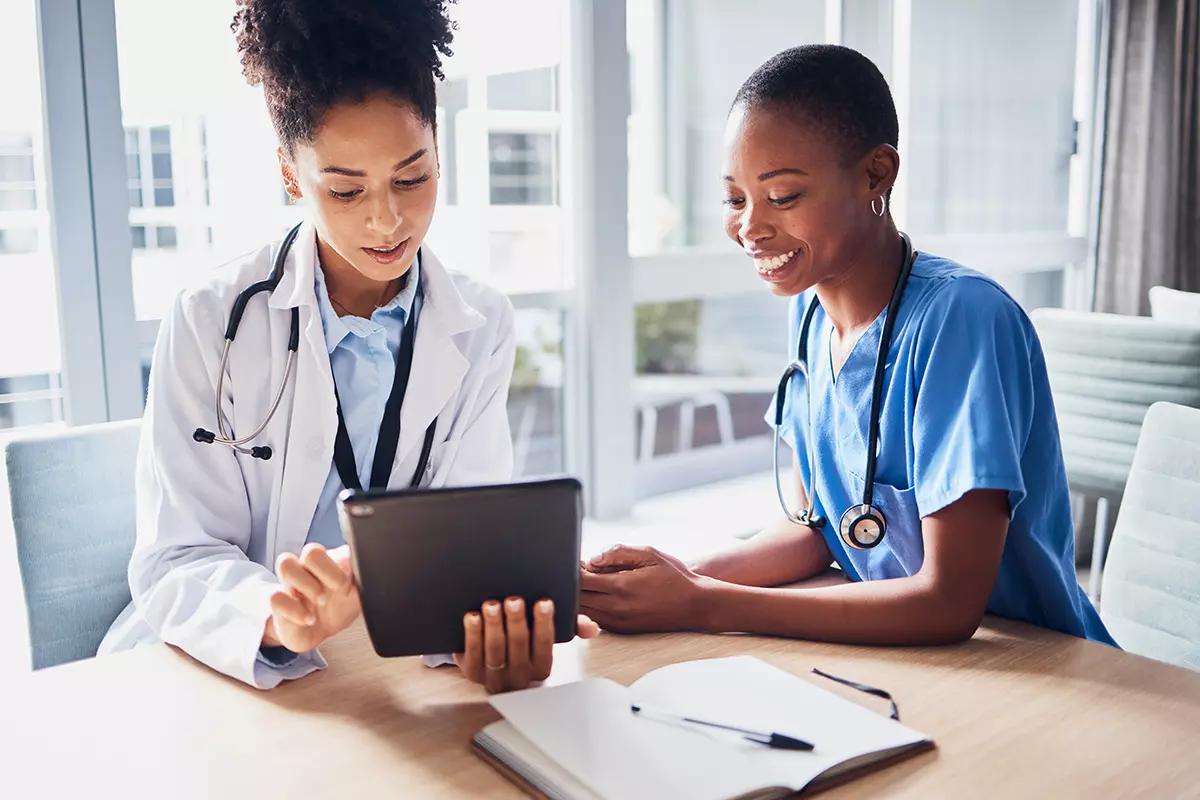 healthcare workers looking at tablet device