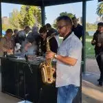 imc employee playing saxaphone at a bbq