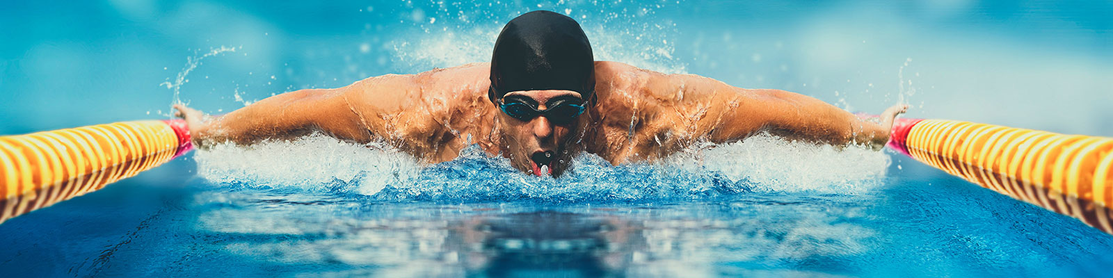 front on photograph of swimmer mid butterfly stroke